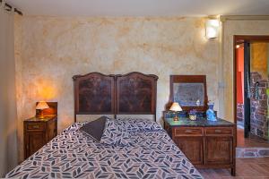 a bedroom with a bed and two dressers and a mirror at Casale Belvedere "L'Ulivo" e "La Terrazza" in Massarosa +32 photos