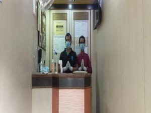 two people wearing face masks in a subway at Hotel O Mega Palace in Patna