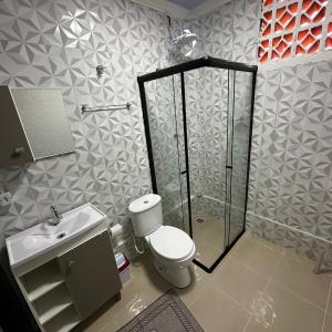 a bathroom with a shower and a toilet and a sink at Loft Lux SM Chapecó - Super aconchegante! in Chapecó