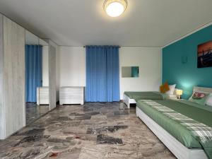 a bedroom with two beds and blue walls at venice popular residence in Mestre