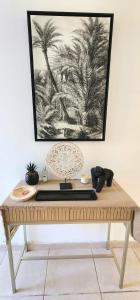 a wooden table with a picture on the wall at Le Nid Bohème -Anse Marcel in Anse Marcel  +31 photos