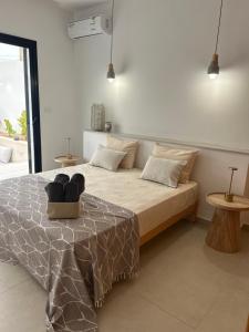 a bedroom with a bed with a table and two tables at Dar El Salem Villa de Haut Standing in Al Maqārisah +19 photos