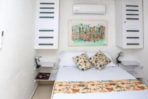 a bedroom with white walls and a bed with pillows at Ocean view - 77Rentals in Cartagena de Indias