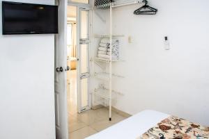 a room with white shelves and a tv at Ocean view - 77Rentals in Cartagena de Indias +19 photos