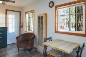 a dining room with a table and a chair at Baby Bear - A delightful studio style property in the perfect central location! in Big Bear Lake
