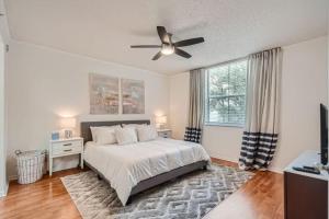 a bedroom with a bed and a ceiling fan at Courtyard Oasis - Drift into Downtown Comfort with Pool Access in West Palm Beach