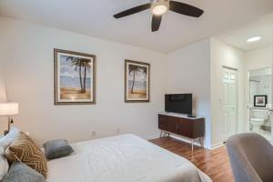 a bedroom with a bed and a flat screen tv at Courtyard Oasis - Drift into Downtown Comfort with Pool Access in West Palm Beach +6 photos