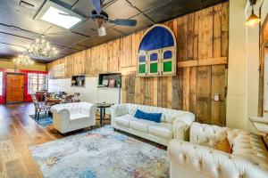 a living room with white furniture and wooden walls at Walkable Townhome M on Main in Wytheville in Wytheville