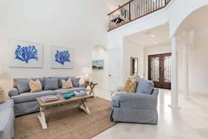 a living room with a couch and a table at Gregory Place - Dine Alfresco by the Pool in South End Sophistication in West Palm Beach