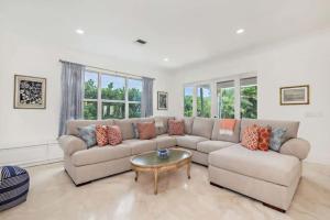 a living room with a couch and a table at Gregory Place - Dine Alfresco by the Pool in South End Sophistication in West Palm Beach