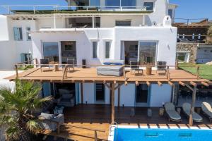 a house with a deck and a swimming pool at M11 - King and Queens Villa - Luxury Villa with pool & gym in Mýkonos City