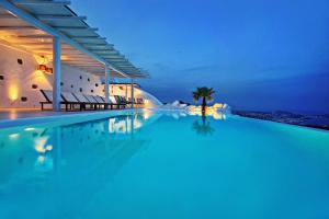 a swimming pool with a palm tree in a hotel at M11 - Aegean Villa - Luxury Mykonos Villa in Mýkonos City