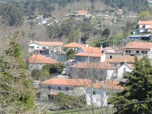 a group of houses with orange roofs on a hill at AL Montenegro in Paredes de Coura