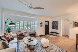 een woonkamer met een bank en een tafel bij Northwood Haven - Light-Filled Bungalow Close to Rybovich Marina in West Palm Beach