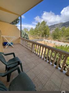 a balcony with a chair and a view of the mountains at Hotel Marino in Baks-Rrjoll +11 photos
