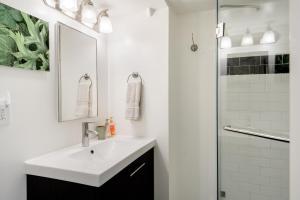 a white bathroom with a sink and a shower at No Car Needed - N Beacon Hill Beauty in Seattle +43 photos