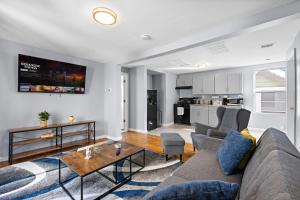 a living room with a couch and a table at Peaceful Hideaway - NYC & NWK with free parking in Newark