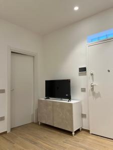 a room with a tv on a cabinet and a door at Cledo Mare Luxury Stay - Benessere in Pescara