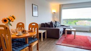 a living room with a table and a couch at Frische-Brise-07-03 in Cuxhaven