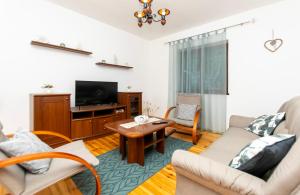 a living room with a couch and a tv at House Ivan in Prigradica