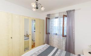 a bedroom with a bed and a window at House Ivan in Prigradica +26 photos