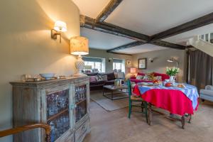 a living room with a table and a couch at Church End Cottage in Milton Keynes