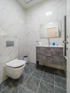 a bathroom with a toilet and a sink at Sea Serenity Achziv in Nahariyya