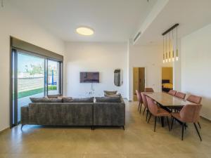 a living room with a couch and a table at Sea Serenity Achziv in Nahariyya