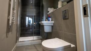 a small bathroom with a toilet and a shower at Mega5 Modern 2Bedroom Luxury Apartment Deansgate-2baths, 2toilets, free on site car park in Manchester