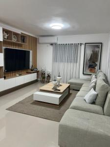 a living room with a couch and a tv at Residencial JL Francia II in Ensanche Savica de Mendoza