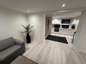 a living room with a couch and a kitchen at Borre in Horten