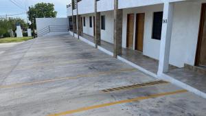 an empty parking lot in front of a building at Palms Suites in Ciudad Acuña +3 photos