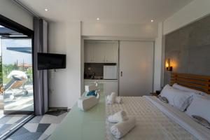 a living room with a large bed and a television at Lobster in Leptokaria