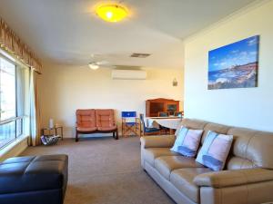 a living room with a couch and a table at Bellavista in Tiddy Widdy
