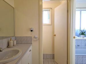 a bathroom with a sink and a mirror at Bellavista in Tiddy Widdy +13 photos