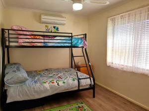a bedroom with two bunk beds and a window at Bellavista in Tiddy Widdy