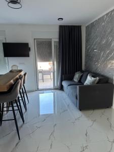 a living room with a couch and a table at Apartments Albatross in Novalja