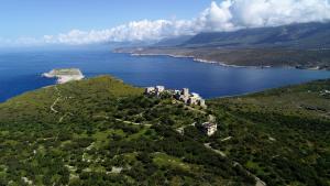 an island in the ocean with a castle on a hill at Mani Fort Charabos in Stavríon