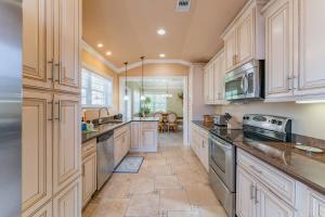 a large kitchen with white cabinets and appliances at Villa La Esperanza-Holmes Beach 201 in Anna Maria Island