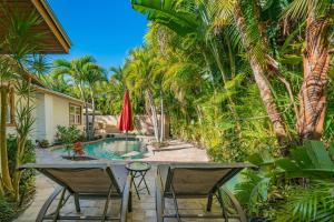 a patio with a table and chairs and a pool at Villa La Esperanza-Holmes Beach 201 in Anna Maria Island