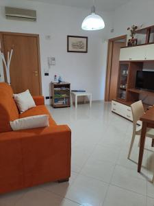 a living room with a couch and a table at Il Giardino Ideal for all seasons in Trapani