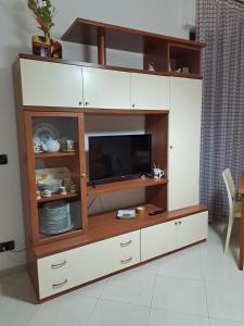 a entertainment center with a flat screen tv in it at Il Giardino Ideal for all seasons in Trapani