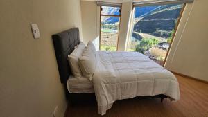 A bed or beds in a room at Amaru TreeHouse