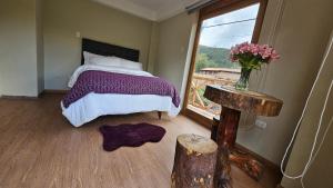 A bed or beds in a room at Amaru TreeHouse