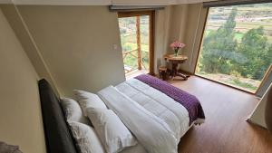 A bed or beds in a room at Amaru TreeHouse