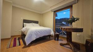 A bed or beds in a room at Amaru TreeHouse