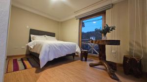 A bed or beds in a room at Amaru TreeHouse