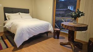 A bed or beds in a room at Amaru TreeHouse