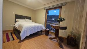 A bed or beds in a room at Amaru TreeHouse