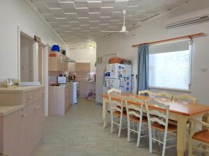a kitchen with a wooden table and chairs at Catalina Cottage in Port Moonta +7 photos